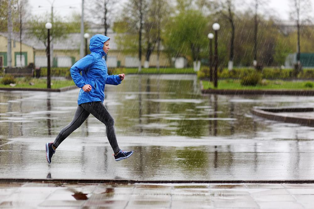 Woman running in rain.