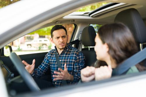 Upset father yelling at daughter in car.