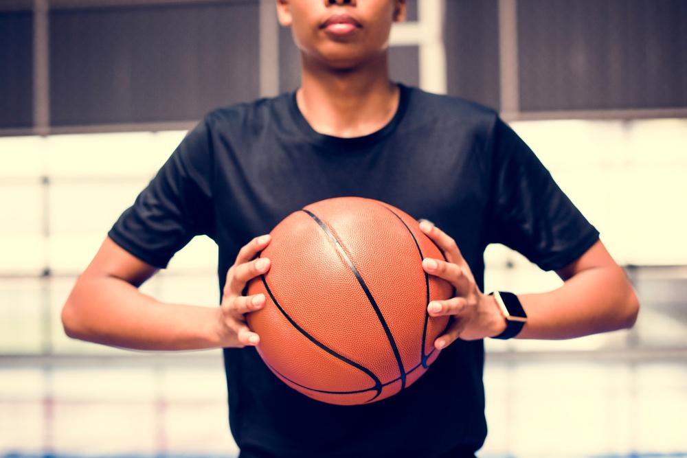 Young black boy holding a basketball.