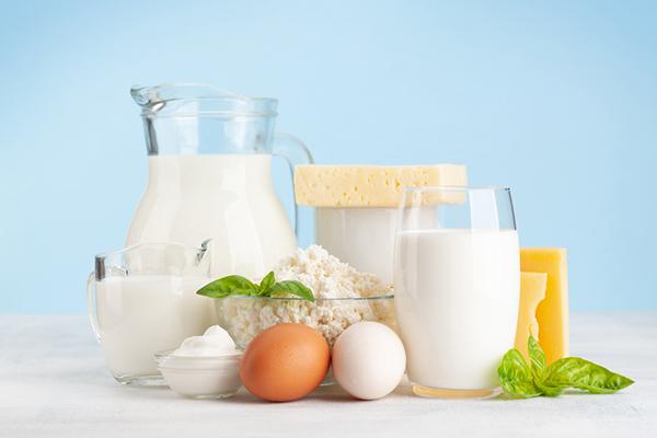 A variety of dairy products and eggs, including milk and cheese.