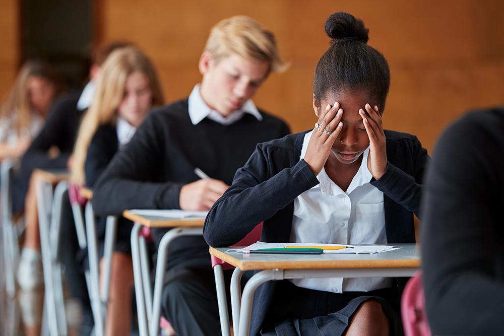 Stressed young student in class.