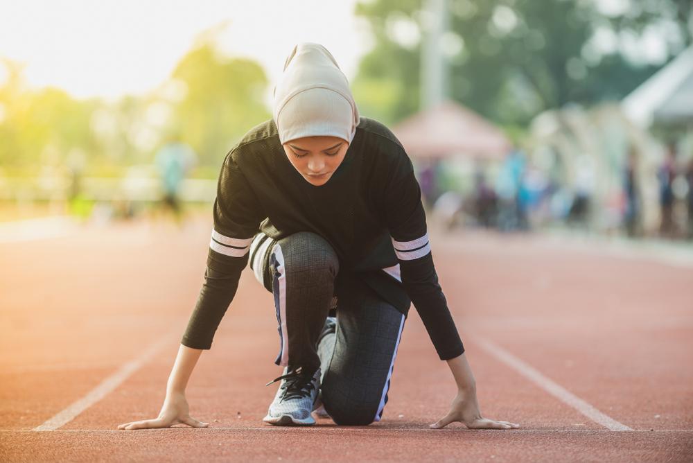 Young muslim woman on track.