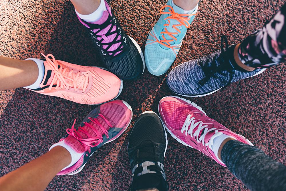 Close up of feet wearing sneakers.