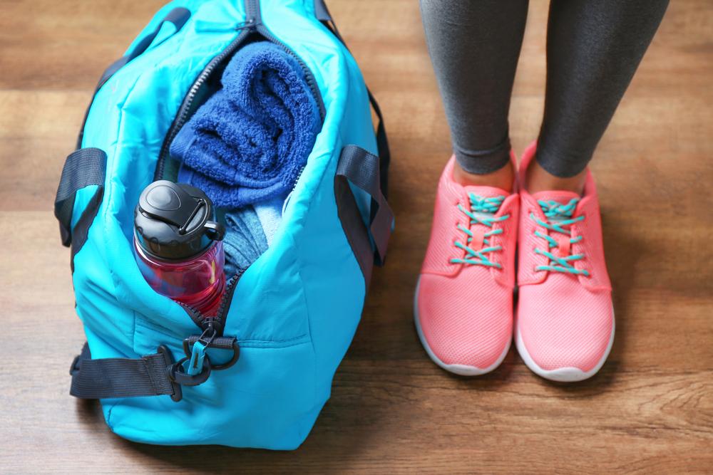 Close up shot of gym shoes and gym bag.