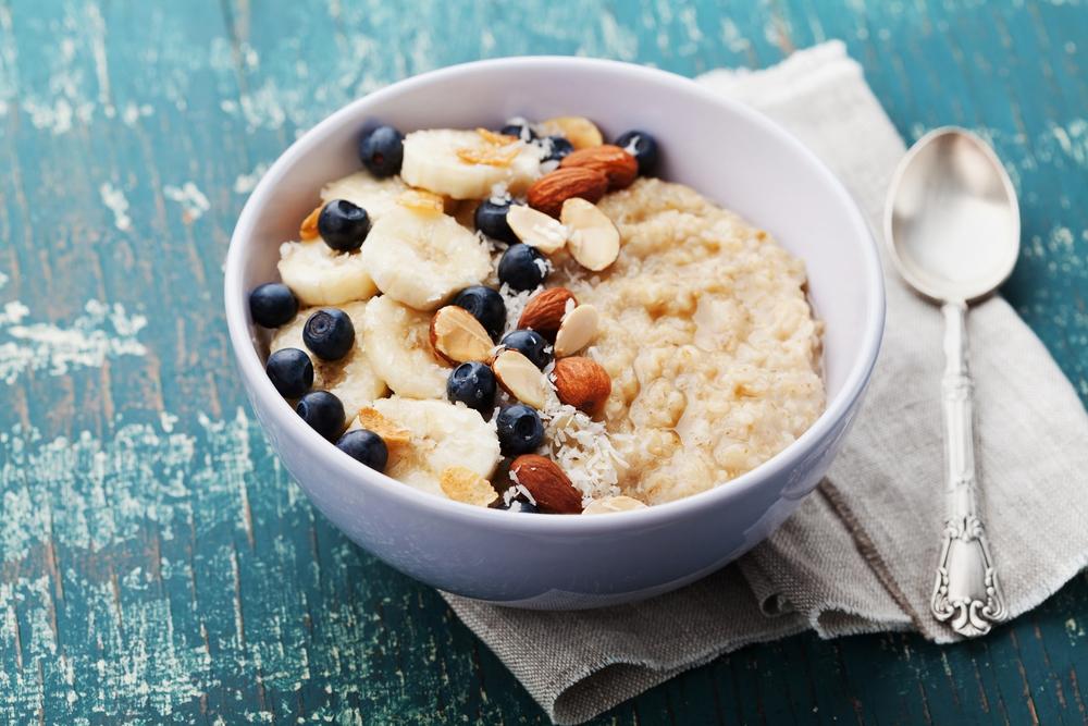 Bowl of oatmeal with fruit and nuts.