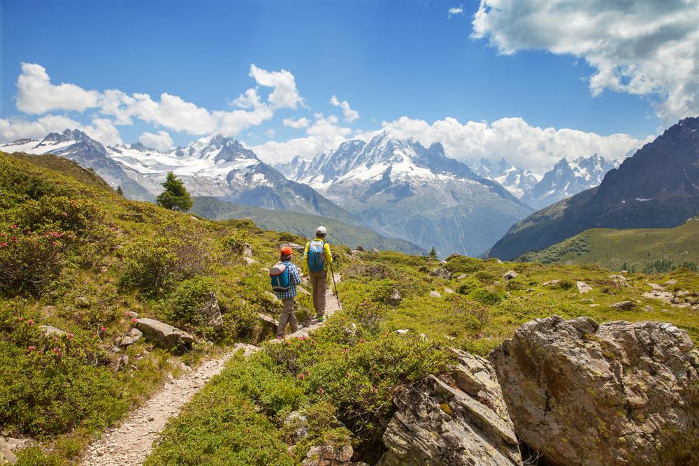 Father and son hiking in mountain range.