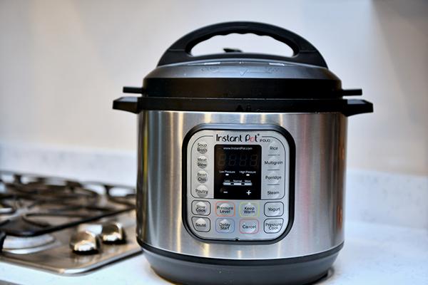 An Instant Pot next to a stove.