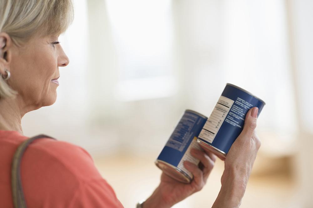 Woman reading nutrition labels.