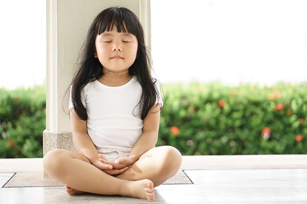 Young asian girl meditating alone.