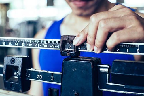 Close up of a manual body weight scale.