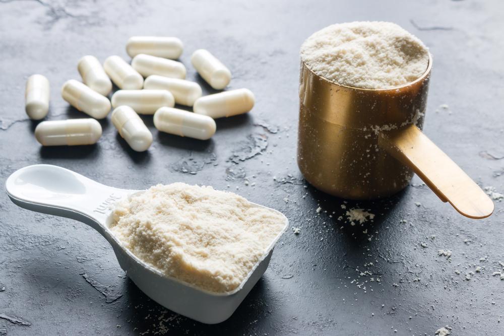 Powder and pill supplements on a table.