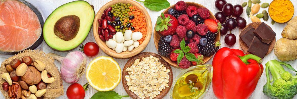 Overhead view of healthy fruits, vegetables, and nuts and fish.