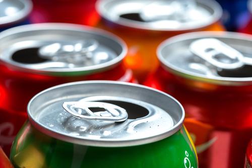 Close up of open cans of soda.