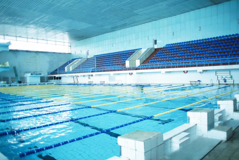 Empty indoor pool with lap lanes.