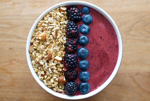 A smoothie bowl with berries and granola.