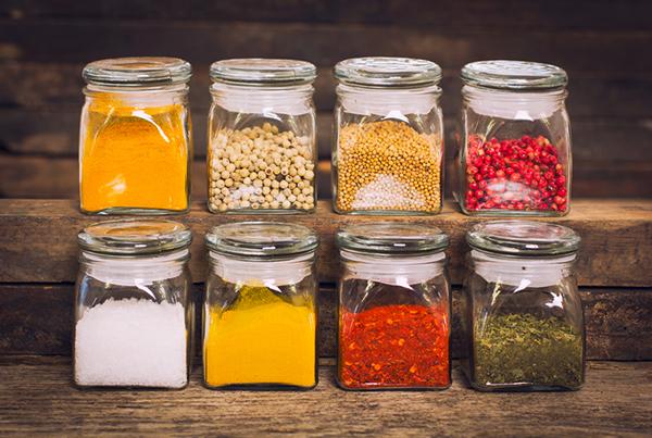 Glass jars of spices on shelves.