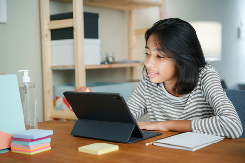 Teen girl on tablet.