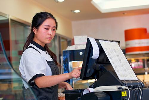 Teen girl working at a store.