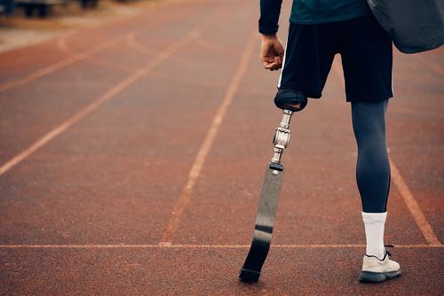 Amputee wearing a spike on a track.