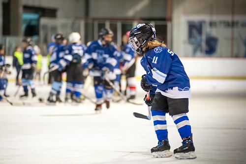 Young female hockey player on the ice.