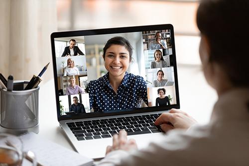 Woman on video call smiling.